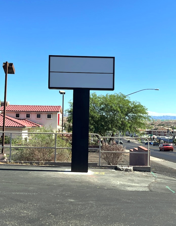 Black pole sign with two blank tenant panels